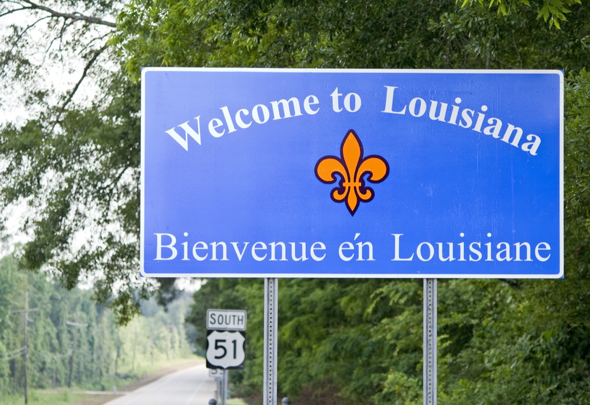 a blue "Welcome to Louisiana" sign off of a highway