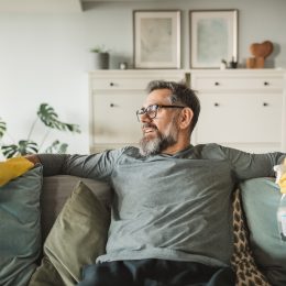 Men resting after cleaning kitchen during pandemic period. He finding way to make isolation period more active