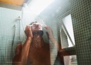 Cropped shot of a man having a refreshing shower at home