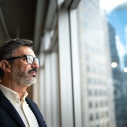 Mature businessman looking out of window