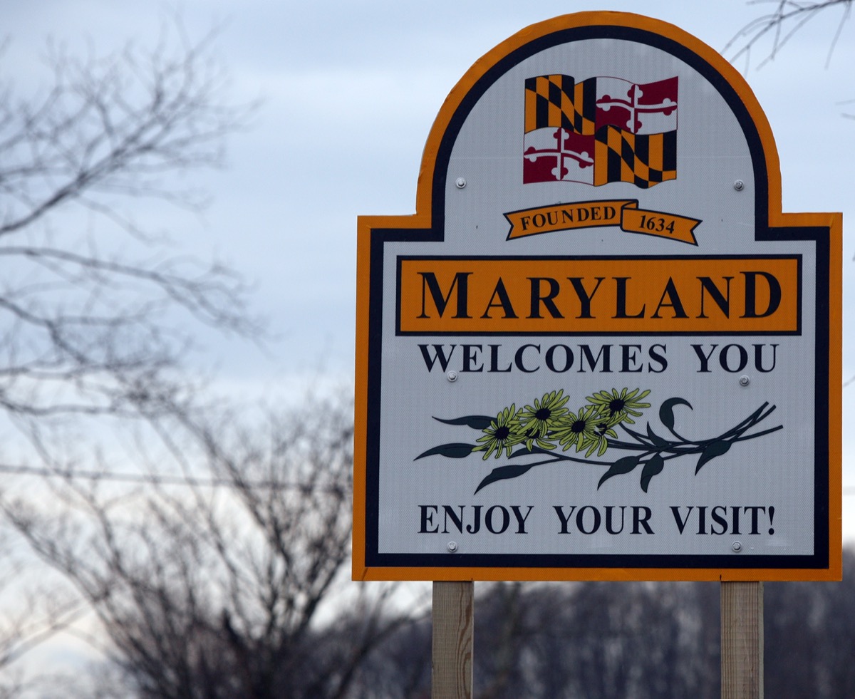 a "Maryland Welcomes You" sign with a white background and oranger border