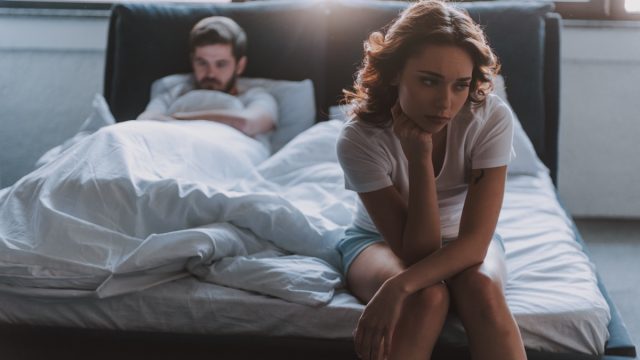 Couple in bed not having sex not talking