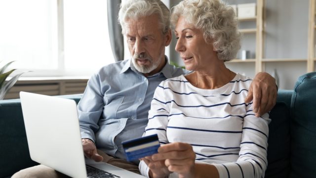 older straight white couple paying bills