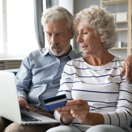 older straight white couple paying bills