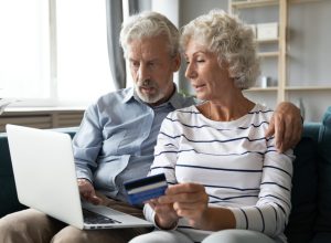 older straight white couple paying bills