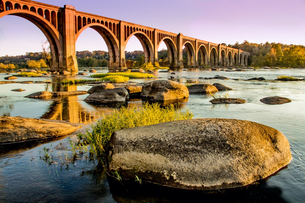 a bridge over and rocks on the James River in Richmond, Virginia