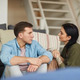 Couple sitting on the floor talking together