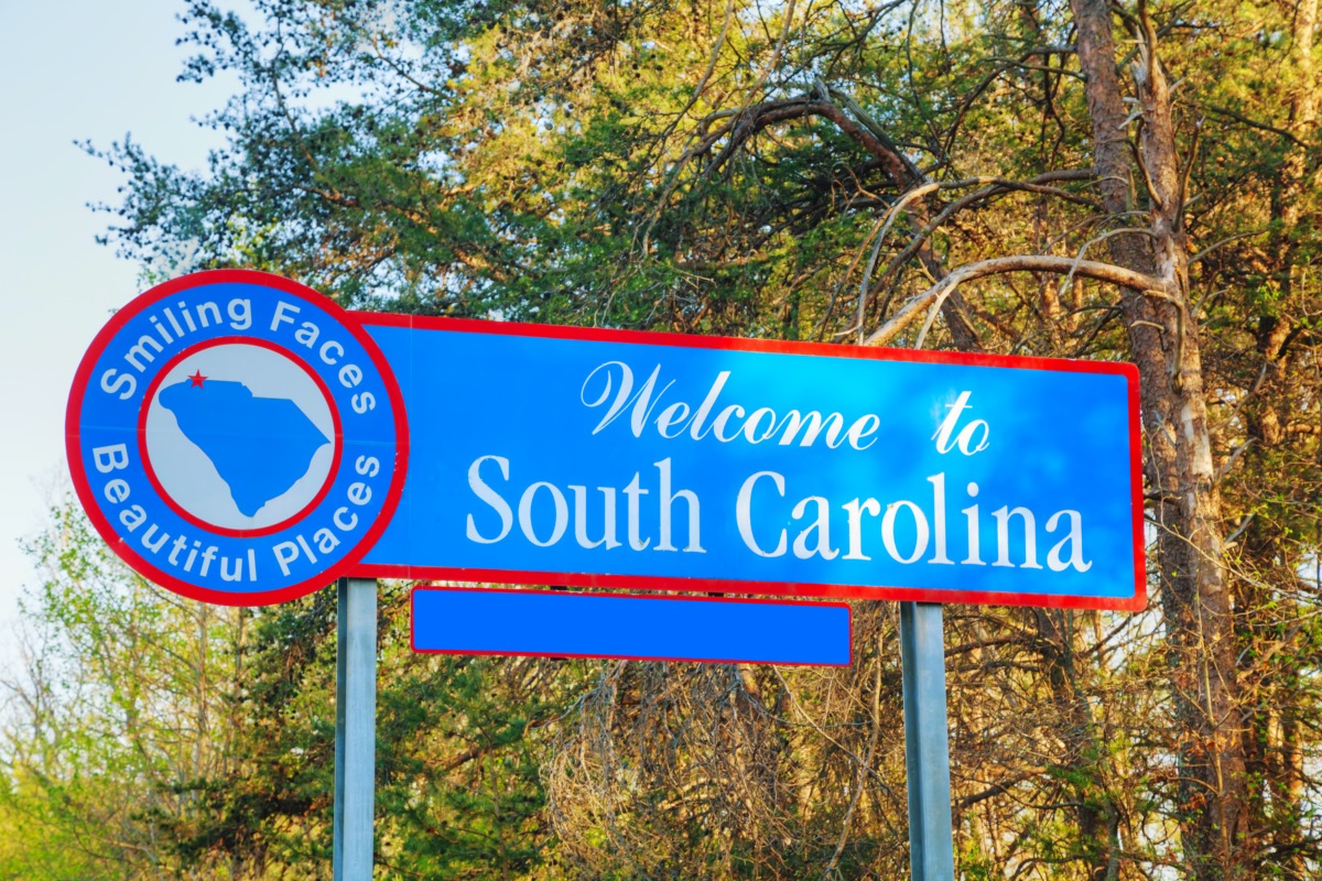 a "Welcome to South Carolina" sign that has a blue background and red border