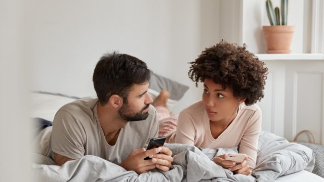 Couple having a serious talk in bed