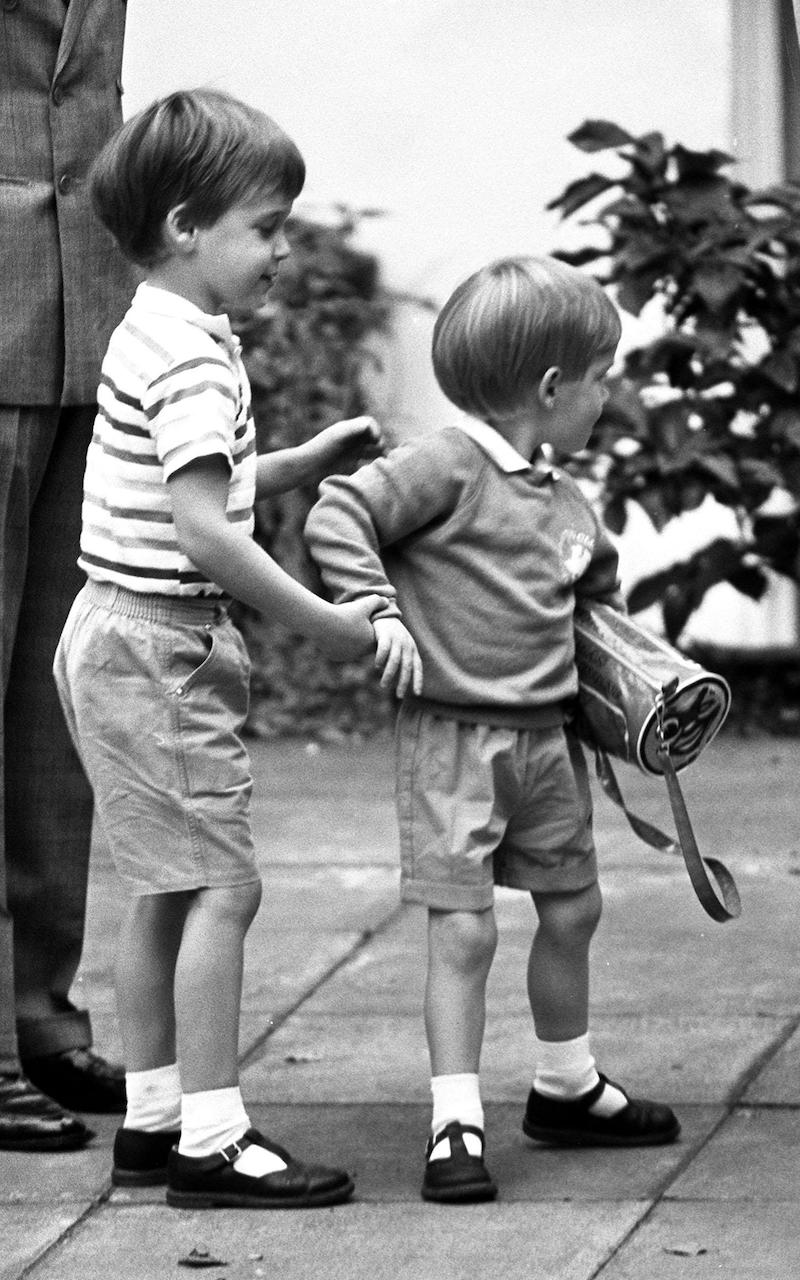 Three year old Prince Harry receives a helping hand from his older brother Prince William on his first day at kindergarten in Chepstow Villas, Notting Hall Gate, London in 1987
