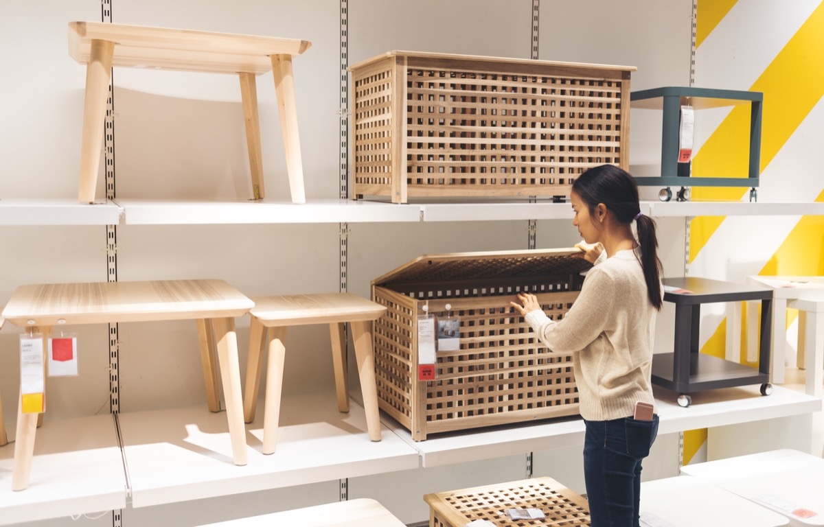woman looking at Ikea furniture to buy