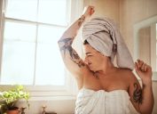Shot of an attractive young woman smelling her armpits during her morning beauty routine