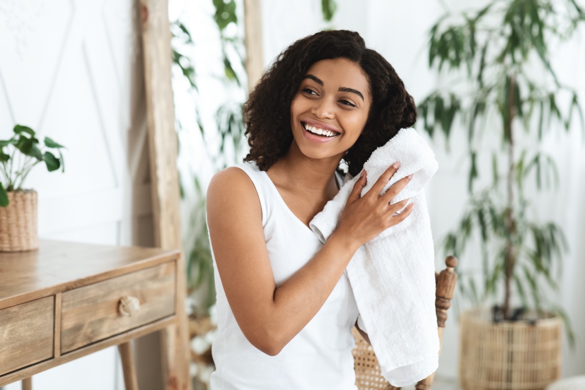 young black woman drying hair with towel