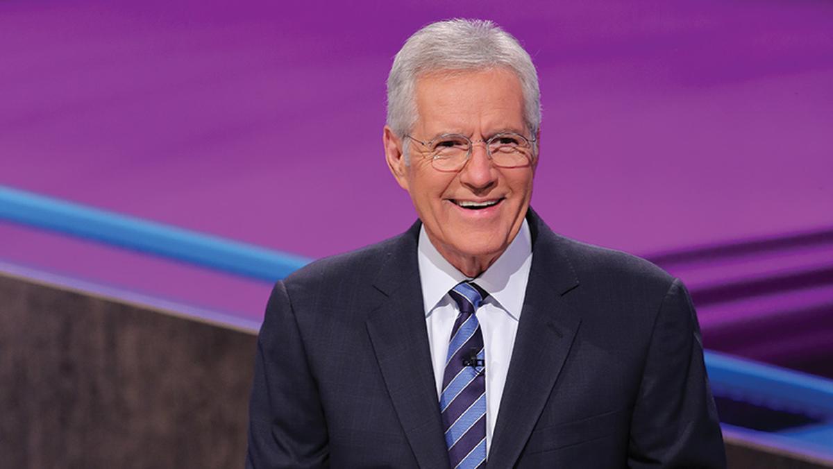 Alex Trebek smiling on the set of Jeopardy