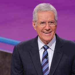 Alex Trebek smiling on the set of Jeopardy