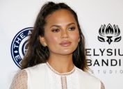 Chrissy Teigen on red carpet, discussing why she won't clap back on social media anymore