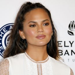 Chrissy Teigen on red carpet, discussing why she won't clap back on social media anymore