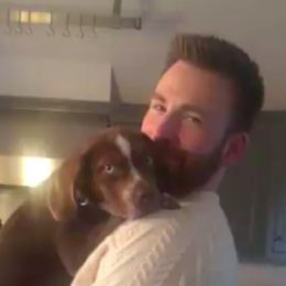 Chris Evans holding Aly Raisman's new puppy