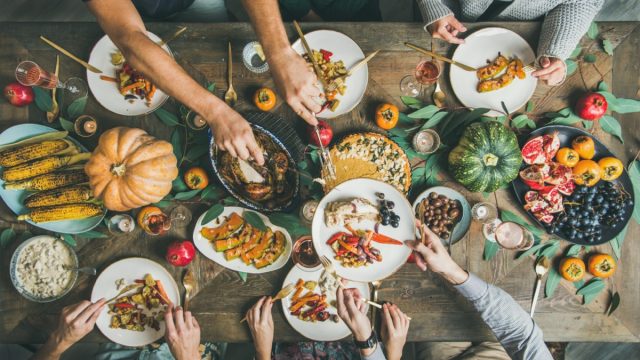 family eating thanksgiving dinner at table in home