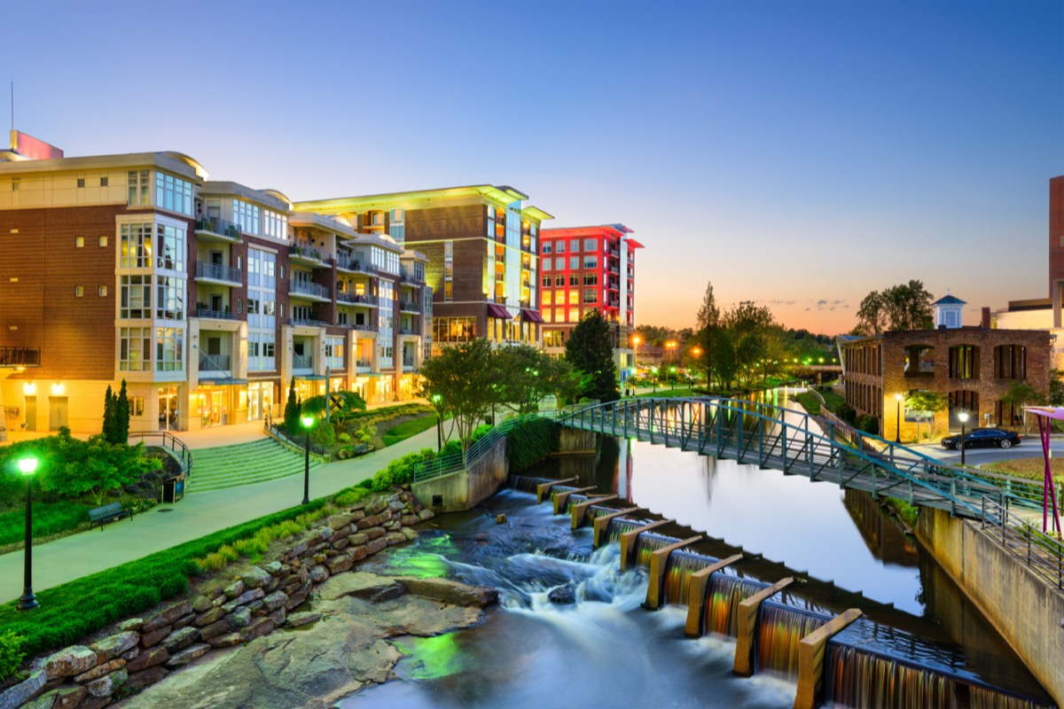 cityscape photos of bridge, lake, and apartment buildings in Greenville, South Carolina at dusk