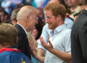 Prince Harry of Wales and Vice President Joe Biden bump into each other in the stands of a wheelchair rugby match during the 2016 Invictus Games at the ESPN Wide World of Sports Complex May 11, 2016 in Orlando, Florida