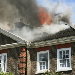 house with roof on fire
