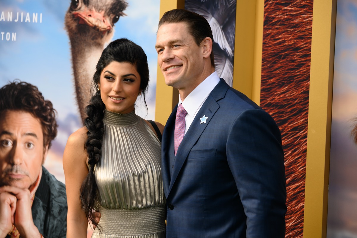 John Cena wears a blue suit and Shay Shariatzadeh wears a silver dress at the premiere of 'Dolittle' in 2020