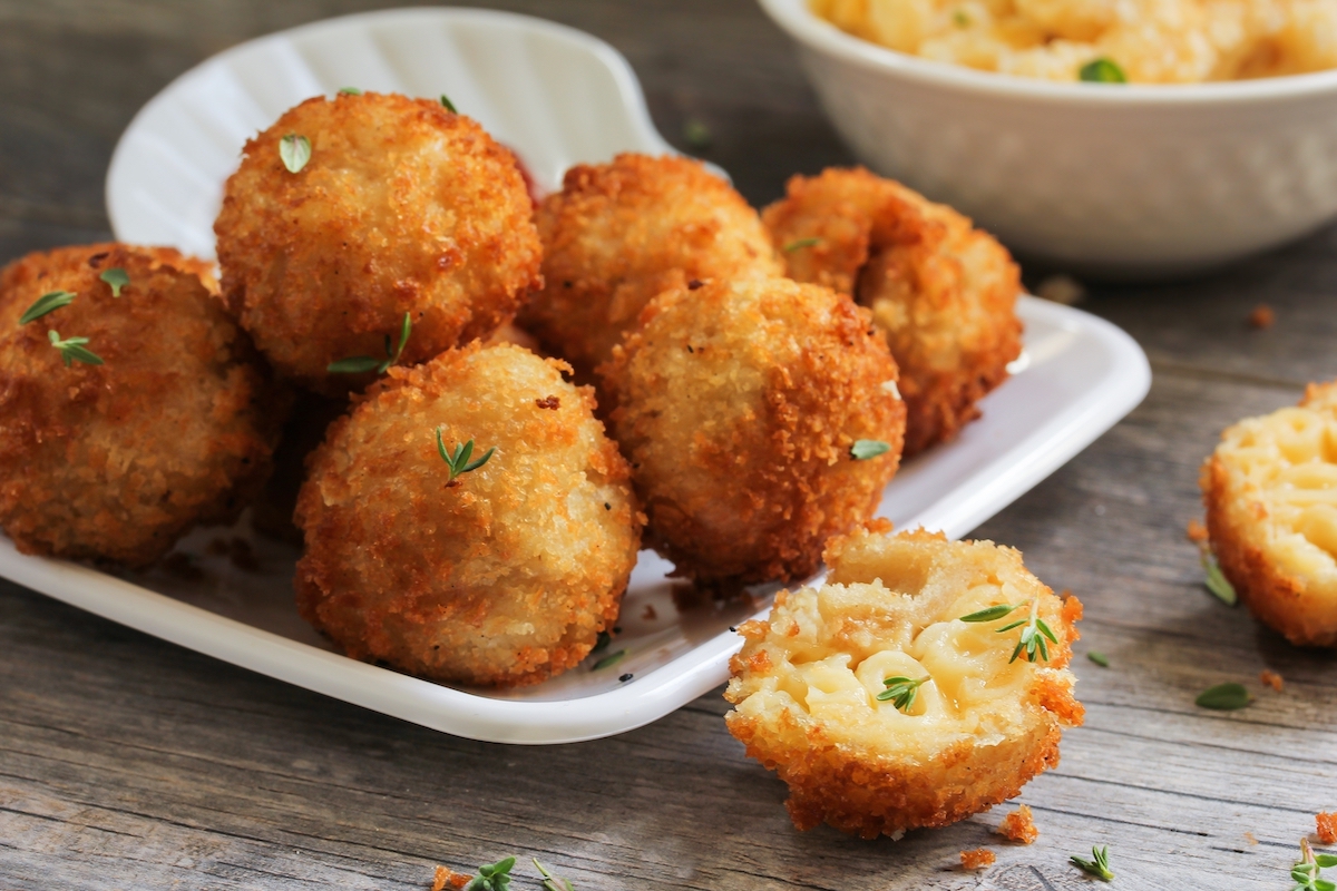 Fried Mac and Cheese balls served on white platter