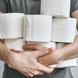 white man holding toilet paper