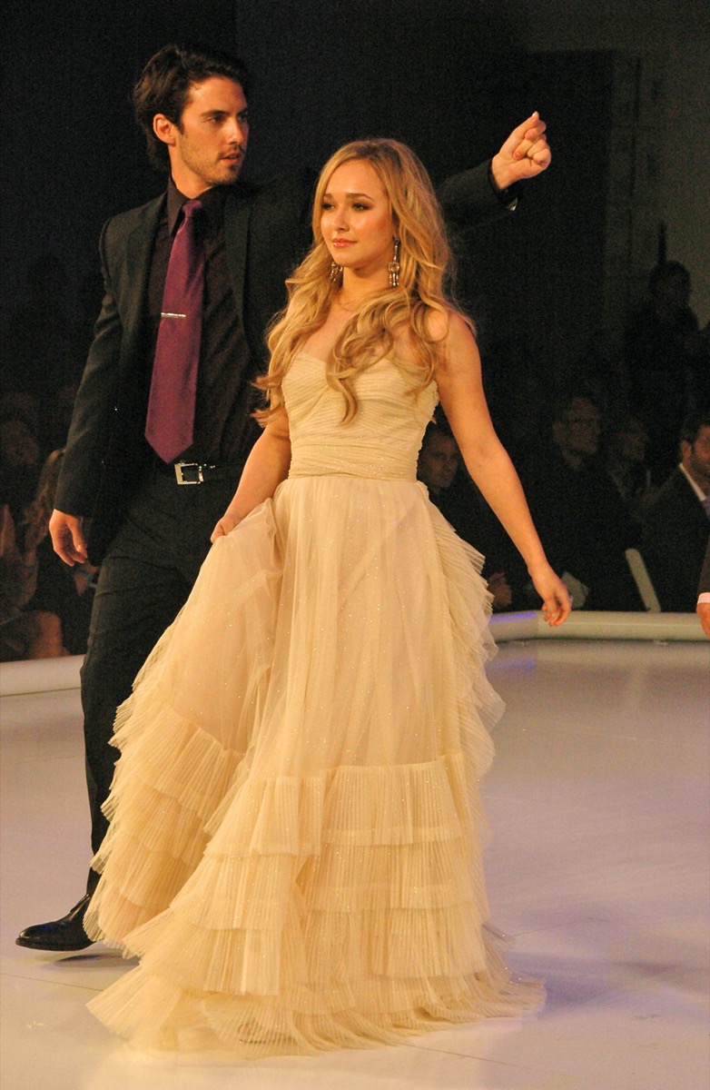 Hayden Panettiere wears a yellow dress and Milo Ventimiglia wears a black suit and purple tie at GM TEN Fashion Show in 2006