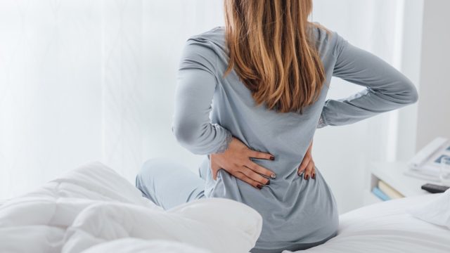 Woman with back pain from sleeping on her stomach