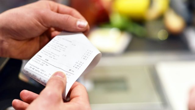 person looking at receipt