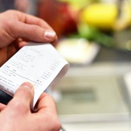 person looking at receipt