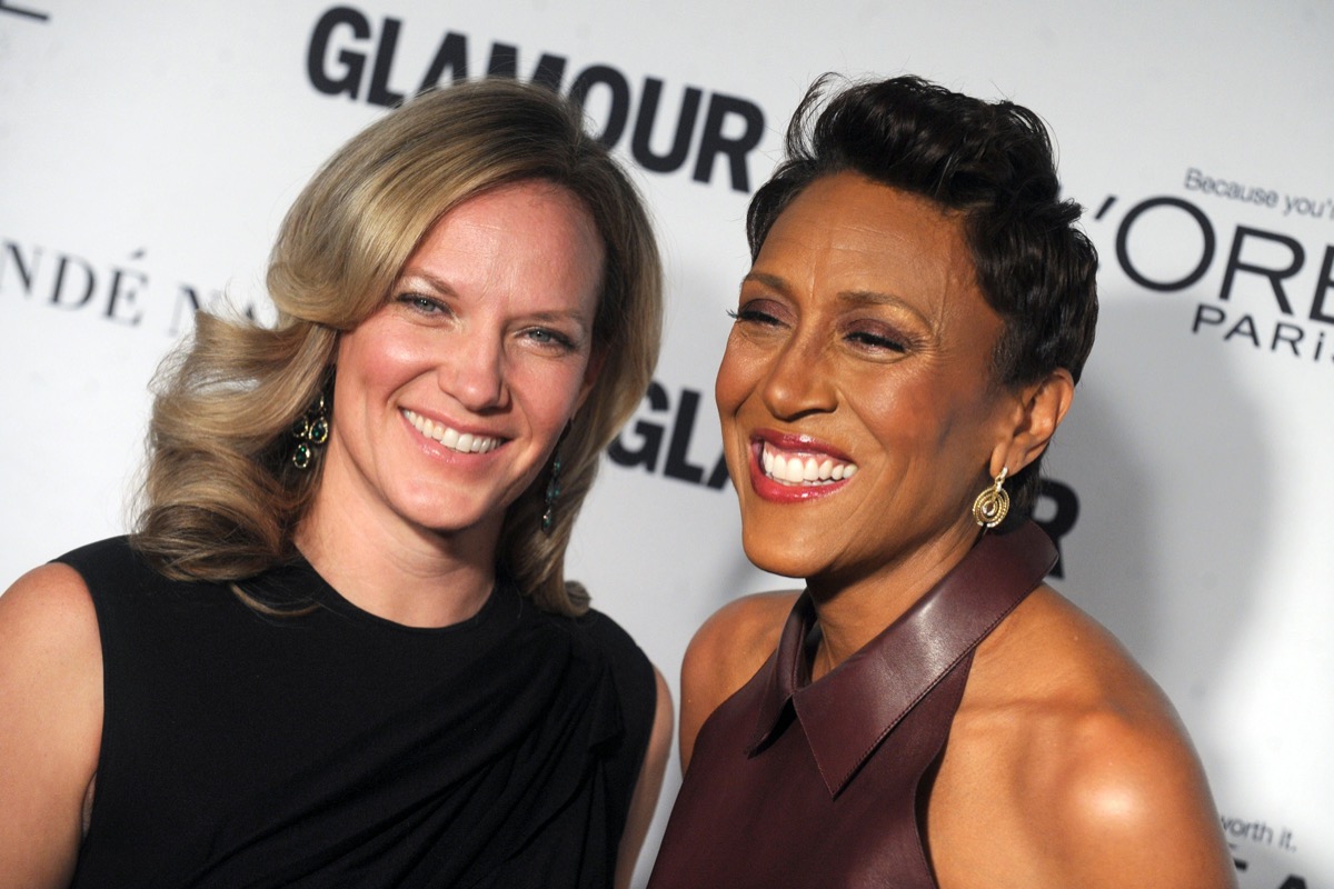 Robin Roberts wears a brown dress and Amber Laign wears a black dress at the Glamour Women Of The Year Awards in 2014