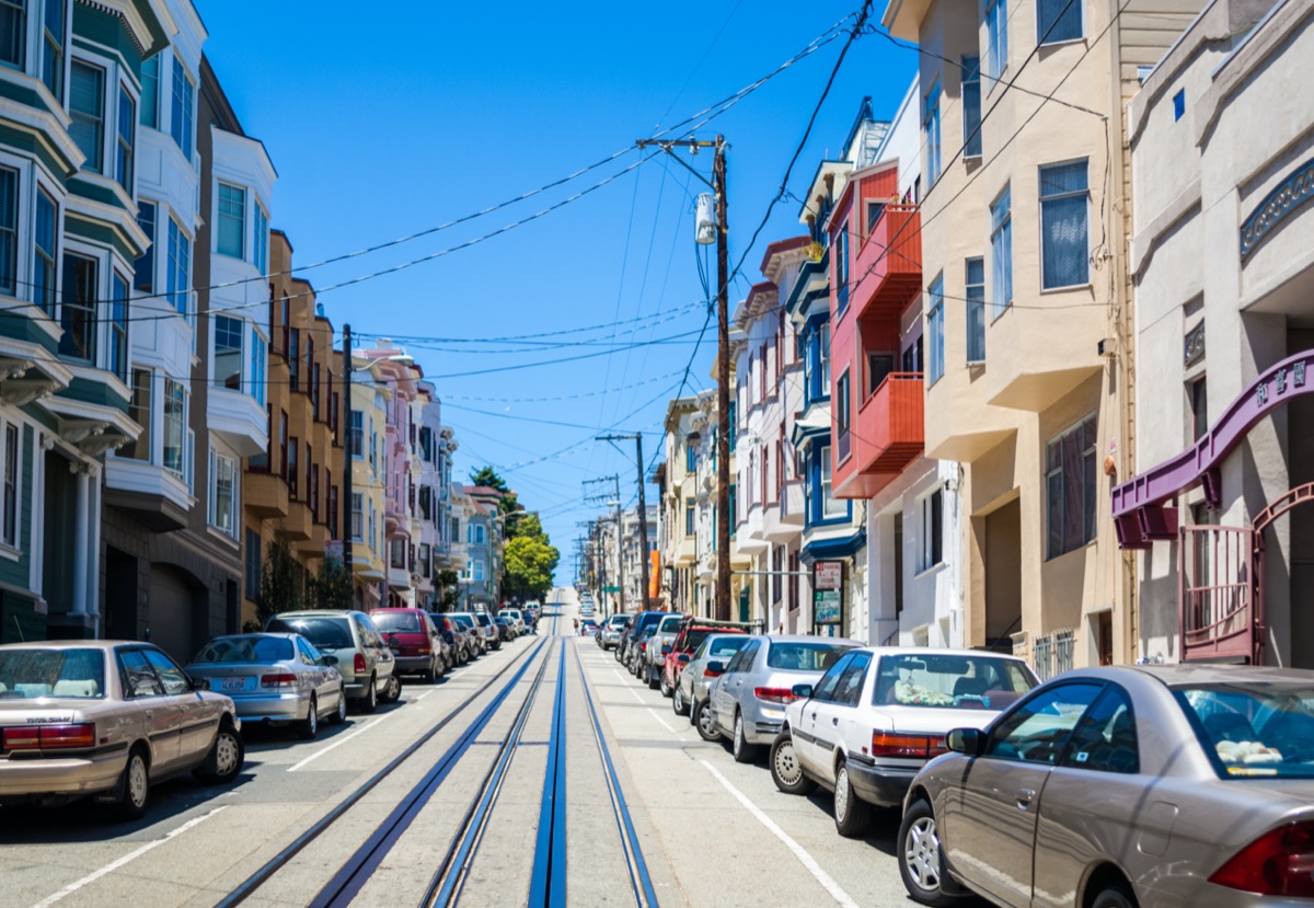 houses and street cars along a hill in San Francisco, California