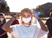Generation Z teens wearing protective face masks during Covid-19 Coronavirus epidemic spread.