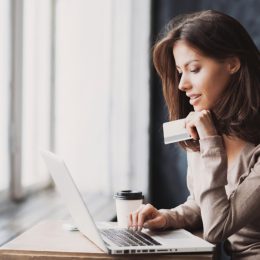 young woman shopping online with credit card