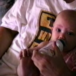 Hailie Jade being held by Eminem in the Mockingbird video