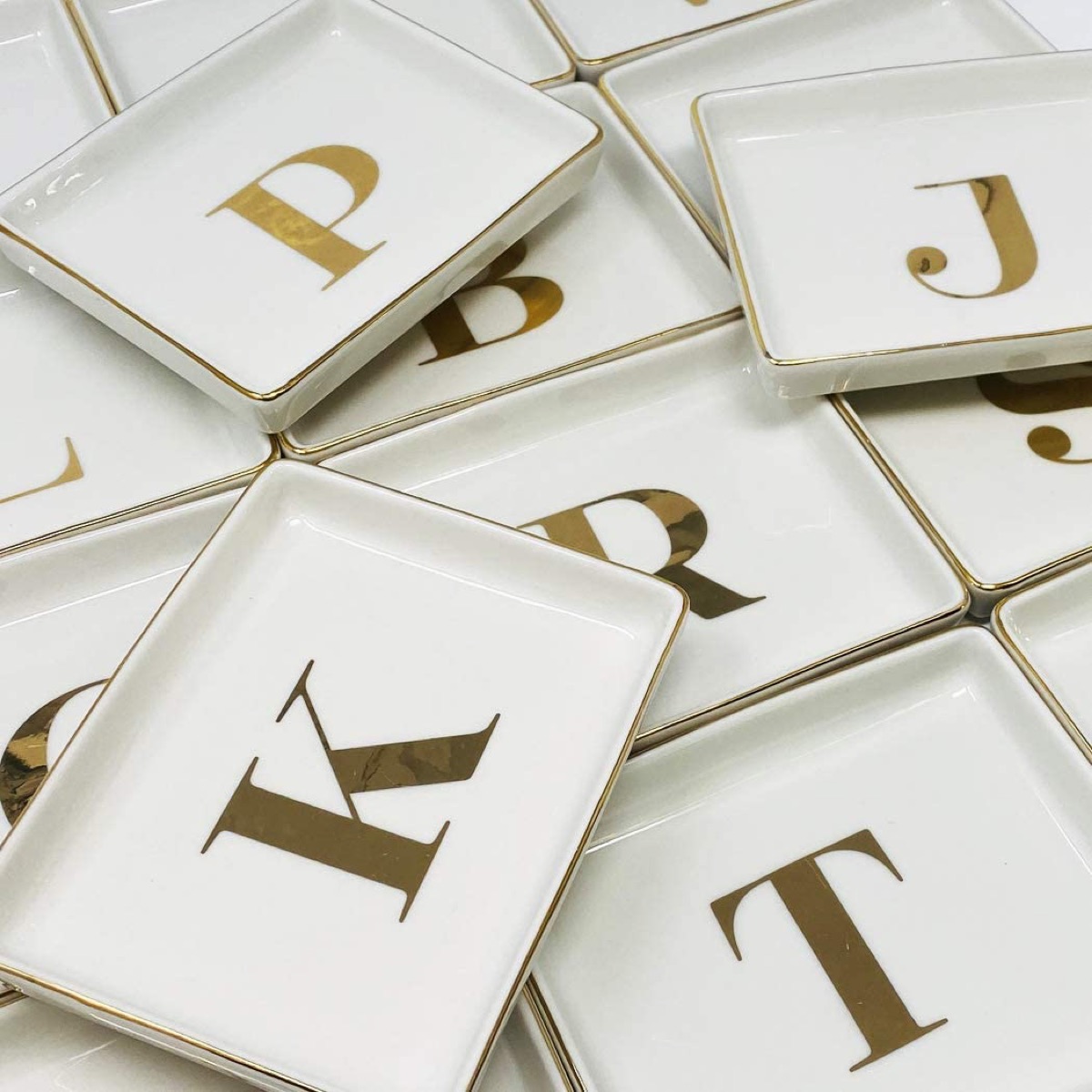 Pile of jewelry trays with initials