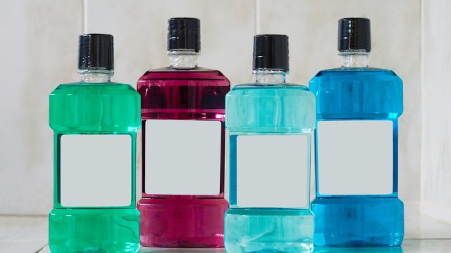 four colorful bottles of mouthwash in the bathroom