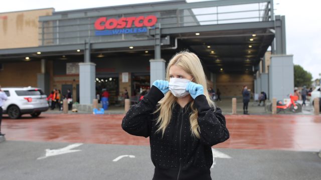 woman wearing face mask and gloves at costco grocery store