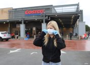 woman wearing face mask and gloves at costco grocery store