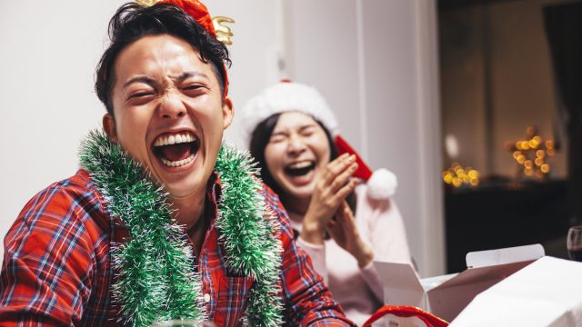 A happy young couple are sharing a good time with laughter on Christmas.