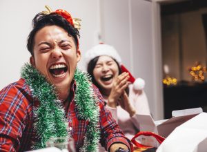 A happy young couple are sharing a good time with laughter on Christmas.