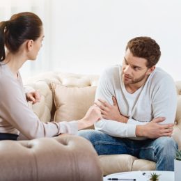 man looking at woman and woman towards to the man on a couch