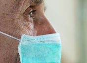 face of elderly man wearing medical facemask