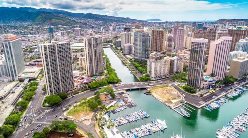 An aerial shot of downtown Honolulu, Hawaii from the water looking inland.
