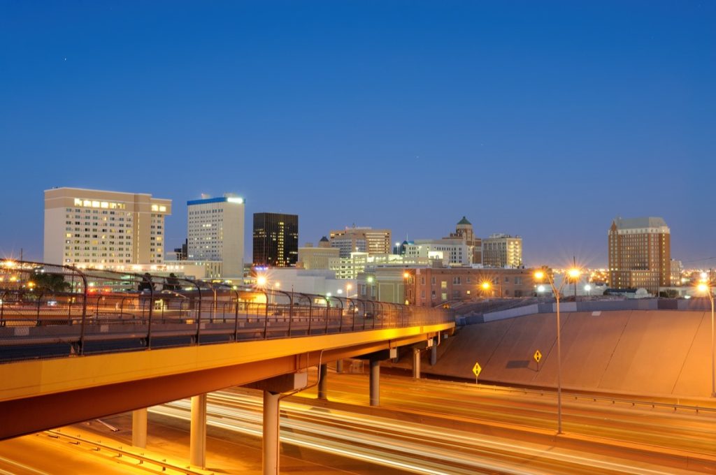cityscape photo of highway, buildings, and bridge in downtown El Paso, Texas at night