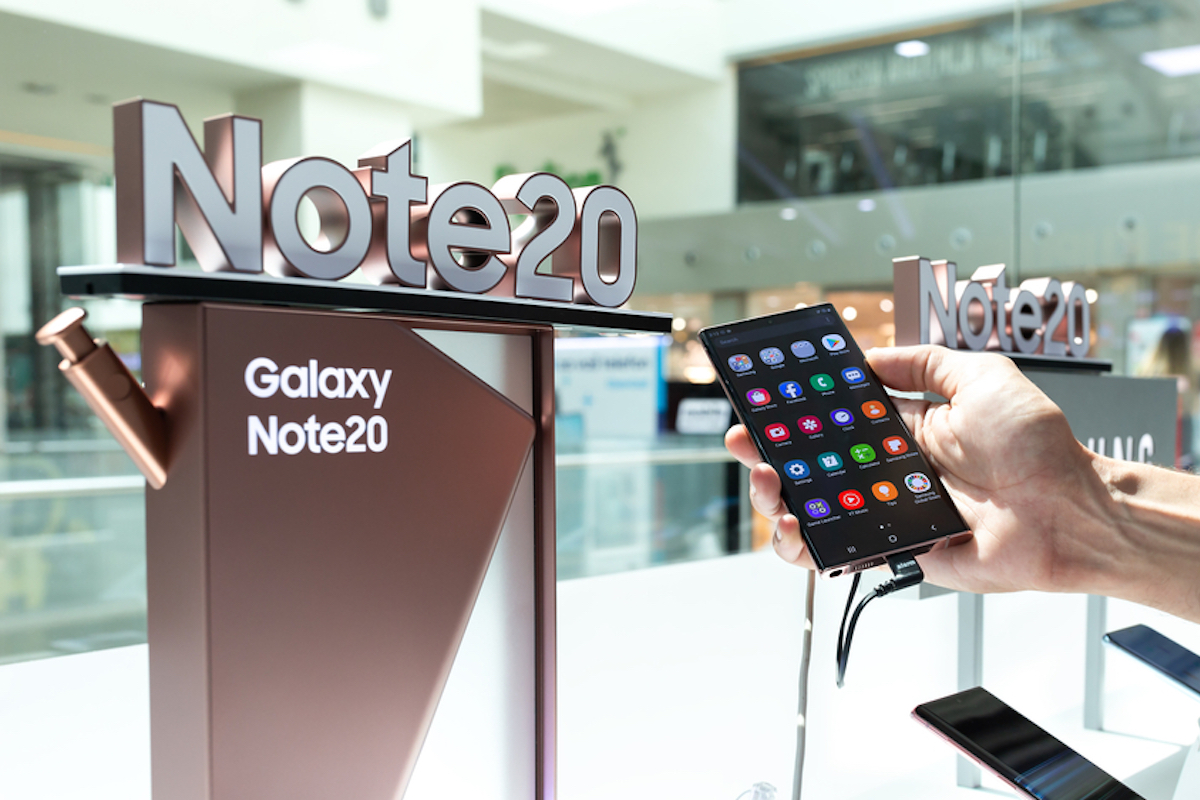 New Samsung Galaxy Note 20 Ultra mobile smartphone is shown with apps on the screen in hand in electronic store.