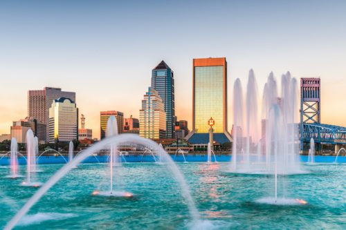 cityscape photo of fountain, buildings, and bridge in downtown Jacksonville, Florida